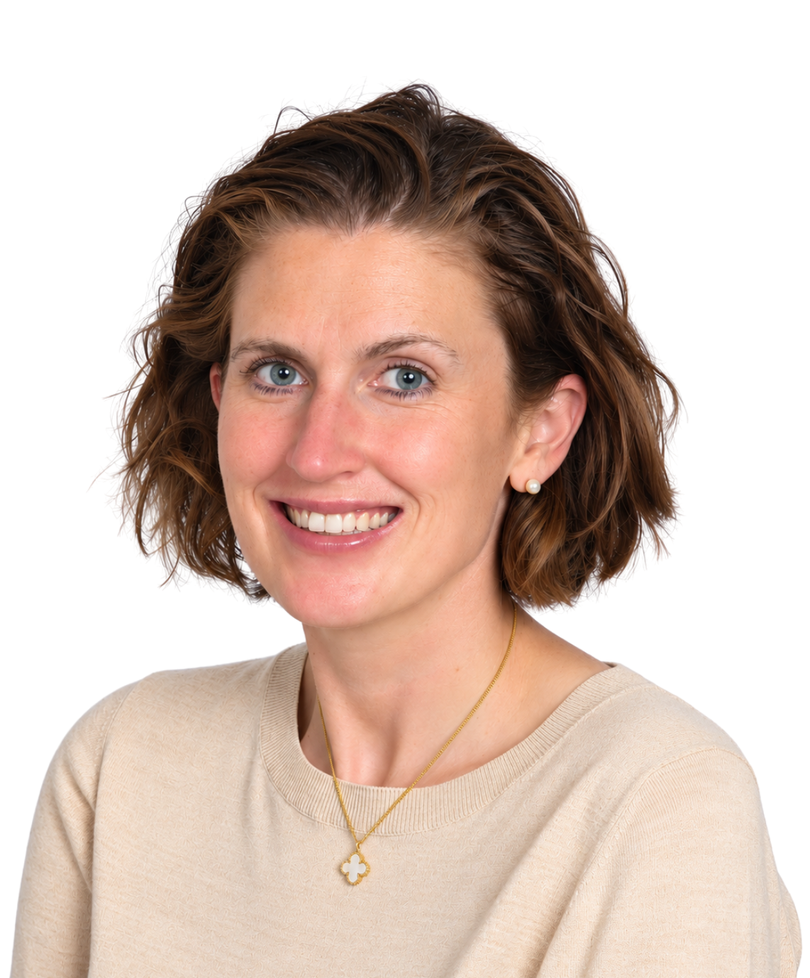 A smiling woman in a tan sweater.